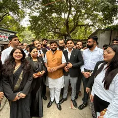 With supporters and colleagues, showing solidarity with important social causes.