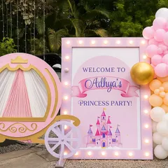Welcome to the ball! This grand entrance for Aadhya's princess party featured a custom-lit sign, a whimsical pumpkin carriage prop, and a beautiful balloon garland to welcome guests to the fairytale.