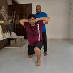 Proven results come from personalized guidance. This image captures a moment of focused effort during an at-home personal training session, targeting leg strength and balance.