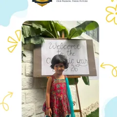 A student dressed in traditional attire poses by our "Welcome" sign on the first day of the academic year. We start every year with a festive and positive spirit.