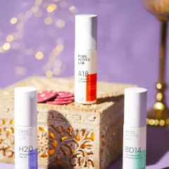 A festive arrangement of skincare products on an ornate wooden box with poker chips. The bokeh lights in the background add a magical sparkle, blending beauty with Diwali celebrations.