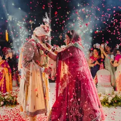 A magical varmala moment, where the couple is showered with rose petals under the spotlight. I focus on creating these picture-perfect memories that you will cherish for a lifetime.