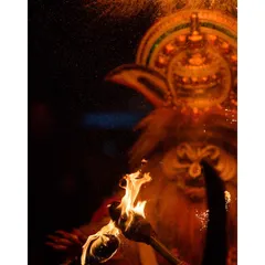A fiery and intense image from a Kathakali performance. The use of real flames and the dramatic lighting captures the raw, primal energy of the character.