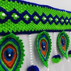 An angled view of the Mor Pankh toran hanging, which shows how the feathers drape beautifully.