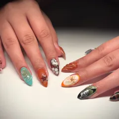 A textured masterpiece on every nail. This set features a variety of 3D designs, including swirls, bubbles, and floral patterns in a mix of earthy and vibrant colors.