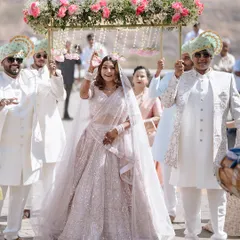The bride's grand entrance under a beautiful 'phoolon ki chadar,' a moment filled with anticipation and emotion as she walks towards her future.