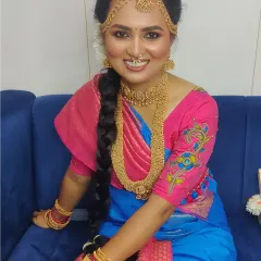 A closer look at the Iyer Madisar drape, showcasing the beautiful way the fabric is styled around the body, complete with traditional jewelry and hairstyle.