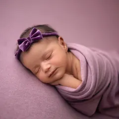 Pretty in purple. This side-lying pose is perfect for showing off your baby's sweet profile, all while they are comfortably wrapped and sleeping.