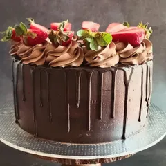 This angle of the Death by Chocolate cake showcases the beautiful, dark chocolate drip effect against the smooth frosting.