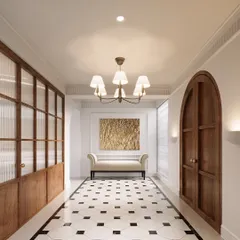 The vestibule was designed as a graceful transition into the home. The classic black-and-white marble flooring, arched wooden door, and ribbed glass partition create a functional and elegant entrance with a distinct European character.