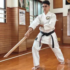 Focus and form are critical in weapons training. A student holds a ready stance with the Eku, demonstrating the concentration taught during our training sessions at the Shorin-ryu Shorinkan Honbu Dojo in Okinawa.
