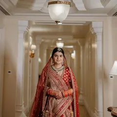 A beautiful bridal portrait in the elegant corridor of The Leela Palace Bengaluru, capturing her poise and the grandeur of the venue.