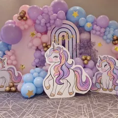 An elegant unicorn theme with a color palette of pastel purple and blue. This setup includes unicorn cutouts, arch-shaped backdrops, and gold star accents for a touch of magic.