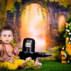 A baby dressed as a devotee of Lord Shiva, sitting next to a Shiva Linga in a divine setting.