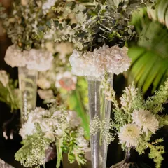For our 'Love & Illusion' Sangeet, we used clean, modern floral arrangements with white hydrangeas and roses to complement the monochrome theme. Sometimes, simplicity is the ultimate sophistication.