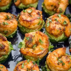 A close-up of our perfectly seared sriracha prawns served on a bed of fresh avocado. Each appetizer is a testament to our commitment to flavor and presentation, designed to be a memorable single bite.