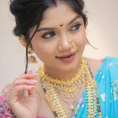 For this client's traditional Maharashtrian look, we chose long, elegant almond-shaped nail extensions with a natural, glossy finish. This style adds grace and completes the look without overpowering the beautiful saree and jewelry.