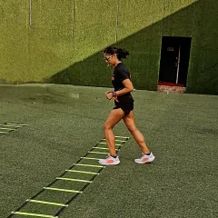 Executing agility ladder drills on the turf. Mastery is hidden in the drills you repeat. This kind of work is crucial for developing quick feet and better coordination.