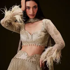 For this ethnic wear campaign, I created a soft glam makeup look with a defined eye and a clean, elegant hairstyle. The goal was to enhance the model's features without overpowering the intricate details of the feathered lehenga.