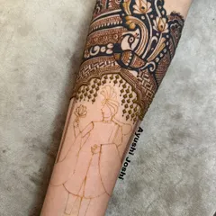 A work-in-progress shot showing the initial outline and partial filling of a groom portrait. This demonstrates the foundational steps to creating detailed figurative mehendi, a technique we cover in depth.