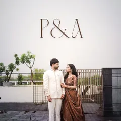 A classic engagement portrait of the newly hitched couple, their initials elegantly displayed above them.