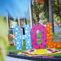 Every angle is an opportunity for a great photo. This shot shows the custom "HOLI" sign from a different perspective, highlighting how such installations can anchor the decor and become a focal point for the event.