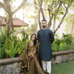 A regal portrait of Rishi and Krishna at the Conrad Bali, their traditional Indian attire standing out beautifully against the lush tropical greenery.