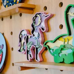 A close-up of the detailed, layered art pieces that are a favorite at the studio. The unicorn and dinosaur are so popular that I made sure to turn them into easy-to-assemble kits for you to enjoy at home.