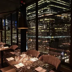 The magic of a New York City evening from our One40 Rooftop restaurant project. We designed this space to capture the city's energy, with floor-to-ceiling windows that frame the glittering skyline, creating an unforgettable dining atmosphere.