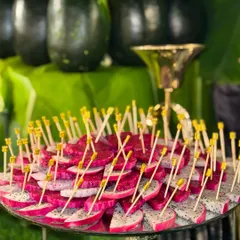 Perfectly sliced and arranged dragon fruit, ready to impress. The vibrant pink and white colors make it a stunning addition to any fruit platter.