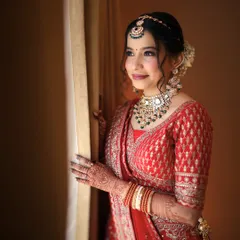 A timeless moment for a classic North Indian bride. This look is all about soft glam, with a flawless base and defined eyes that complement her elegant red lehenga.