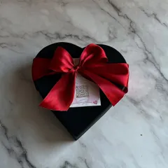 The packaging is part of the gift. My Valentine's assortment comes in this elegant, heart-shaped black box, tied with a luxurious red satin ribbon to make a beautiful first impression.