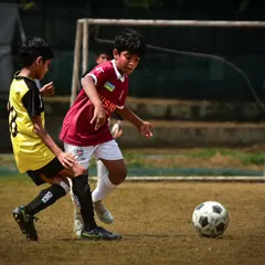A player dribbles past a defender in an RSA Cup match. Moments like these showcase the 1v1 skills and confidence our players develop.
