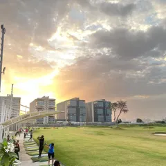 Teeing off into an enchanting sunset. The beauty of nature and the joy of golf collide perfectly at our scenic range.