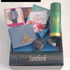 I love putting together these complete gift hampers. This one includes a personalized denim wallet, a name-engraved temperature bottle, a watch, sunglasses, and a men's deodorant, all beautifully arranged for a special birthday surprise.