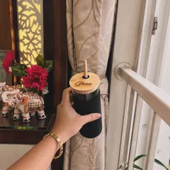 This is my popular glass sipper with a bamboo lid and straw, customized with the name "Ghun." It comes with a black sleeve for a comfortable grip and a sleek, modern look.