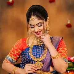 An elegant portrait from a styled shoot, focusing on the rich colors of the saree and the flawless bridal makeup.