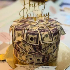 A million-dollar smile for a dollar cake. We had so much fun creating this money-themed cake, covered in edible dollar bills, for a wonderful client.