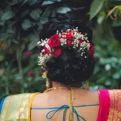 A bridal hairstyle should be a crown. I created this beautiful bun, or 'khopa', and adorned it with fresh red roses and baby's breath, a timeless combination that adds romance and elegance to the overall look.