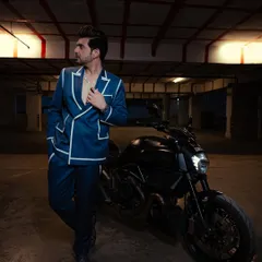 The double-breasted design and bold white piping on this custom suit created a distinctive and modern red carpet look for Karan Kundrra.