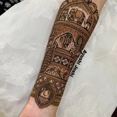 The fully completed armband, showing the majestic elephant, intricate paisleys, and a graceful swan, all brought to life with detailed henna work.
