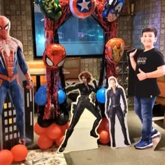 The birthday boy posing with a Spiderman cutout at his Avengers-themed party. We can provide various photo opportunities and props for guests.