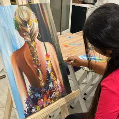 This beautiful painting of a girl with flowers in her hair showcases how we blend portraiture with floral elements. The student did a wonderful job on the soft skin tones and the texture of the braid.