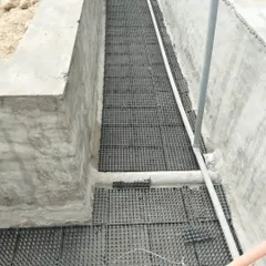 This is the start of a project in Gurugram. We are installing drainage cells in a large concrete planter. This is a crucial first step to ensure proper water drainage and prevent root rot.
