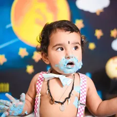 Covered in blue frosting and happiness. This superhero-themed cake smash was all about celebrating this little guy turning one with a fun and playful setup.