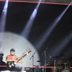 On a big stage with a full drum kit behind me. This setup is for my fusion gigs, where the sitar takes on a new life with powerful rock or electronic beats.