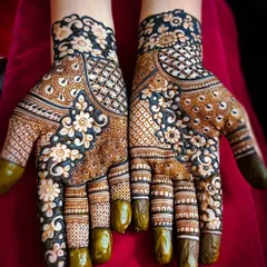 This is a reverse-fill or negative space floral design, where the background is filled with dark henna, making the flowers pop. It's a modern technique that creates a dramatic and beautiful contrast on the hands.