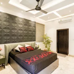 A full view of the bedroom from image 13, showing the sleek white wardrobes and floating TV unit.