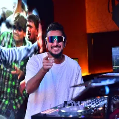 Pointing at the crowd while a classic Bollywood music video plays on the screen behind me. This is live VJing, where I mix the video and audio together.