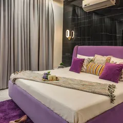 I recently completed this gorgeous bedroom, where a lilac-colored bed serves as the focal point. The design is balanced with a dramatic black marble wall and soft, ambient lighting for a chic and modern feel.